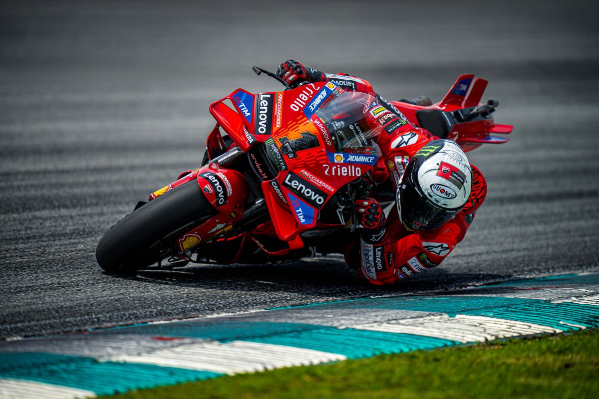 Ride-height device deployed beneath a Ducati GP tail section, showing the actuator and hinged linkage