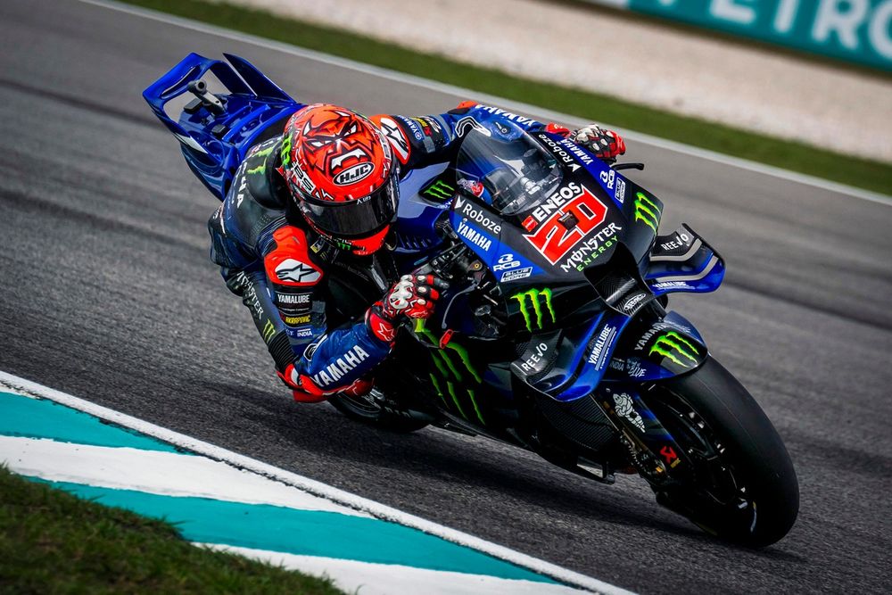 Fabio Quartararo leaning into a high-speed corner on his Honda, showing smooth body position and precise throttle control