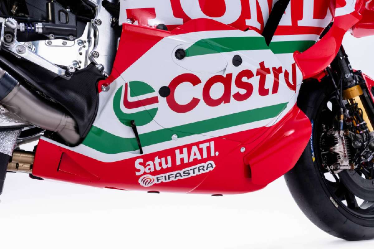 Close-up of the RC213V front wheel and suspension components with visible blur suggesting vibration