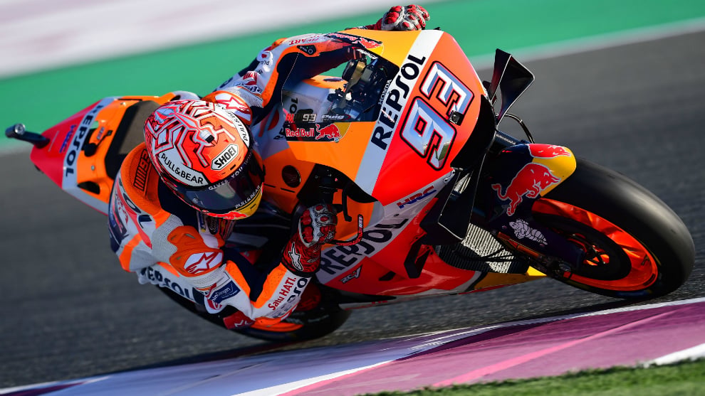 Wide shot of the Repsol Honda factory garage showing crew, bikes and pit equipment during a MotoGP test