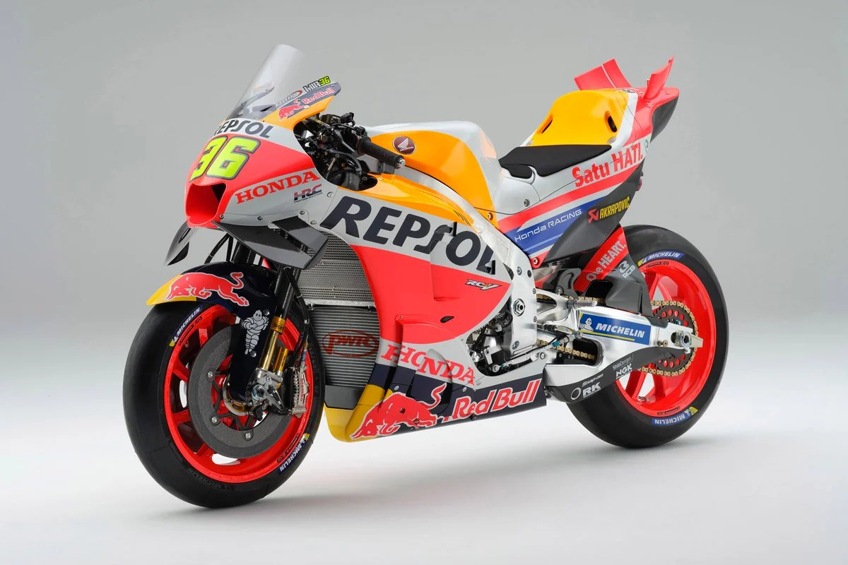HRC engineers examining the Honda RC213V electronics and suspension components at the workbench