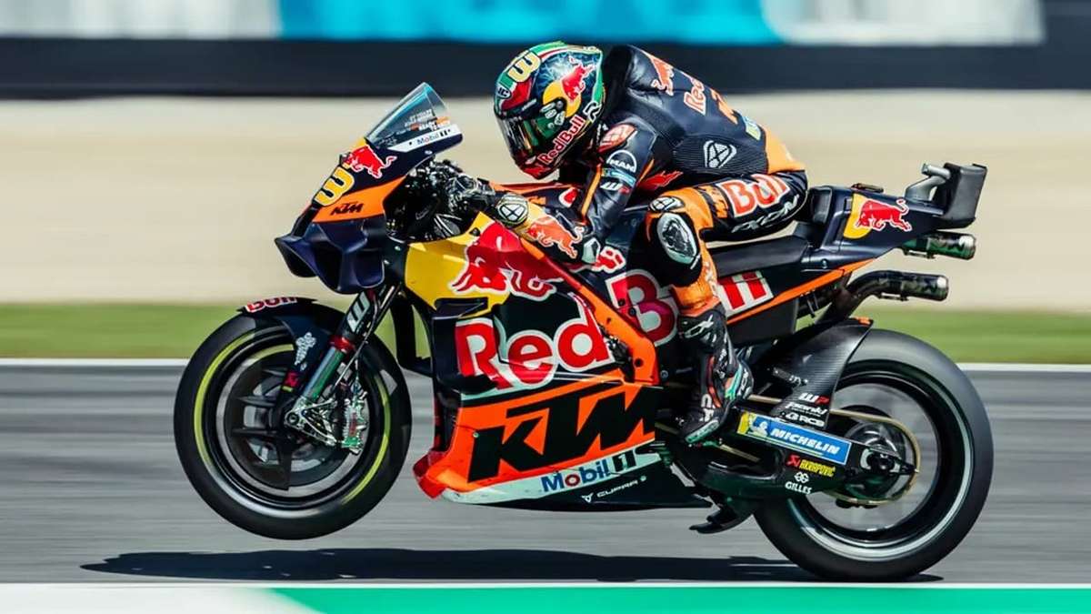 Side profile of the KTM RC16 on track showing aerodynamic fairing and chassis lines
