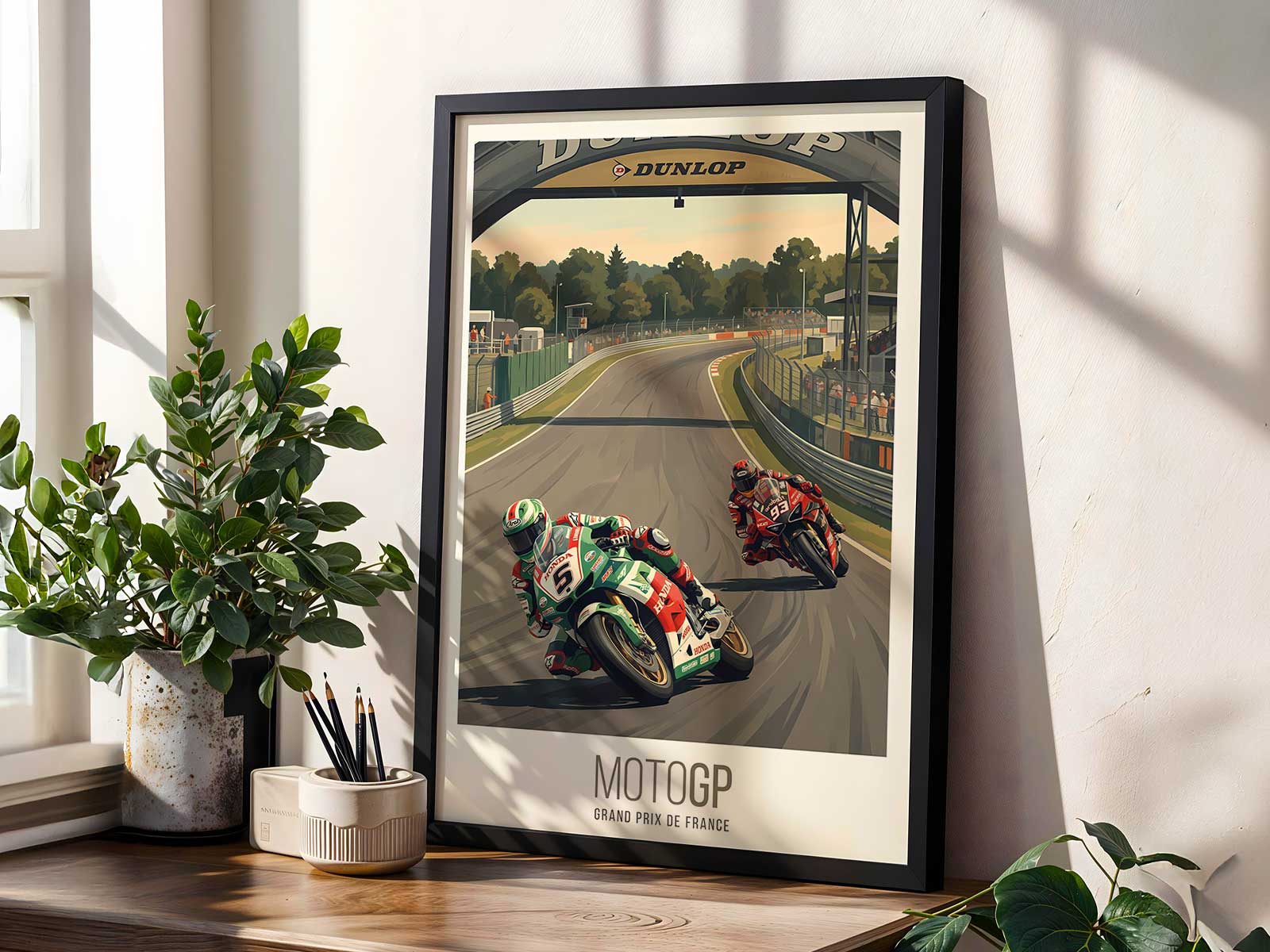Two Aprilia riders running side by side through the Le Mans chicane during a heated battle for the lead