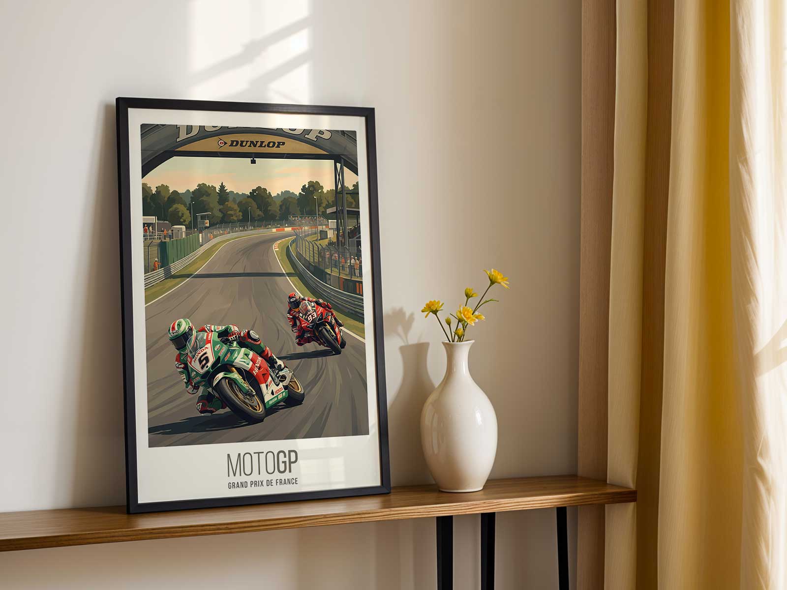 Aerial view of the Le Mans MotoGP circuit at dawn with soft golden light and long shadows across the track