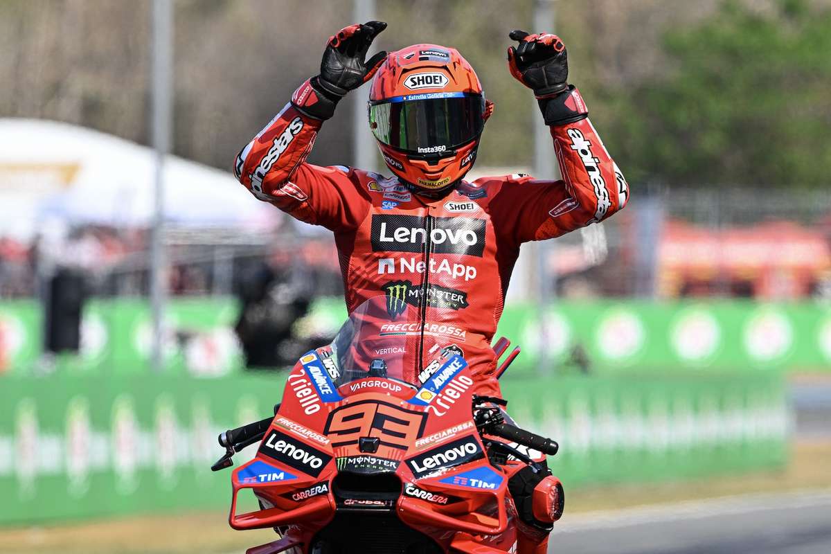 Ducati pit crew working on Marc Márquez's bike during a technical stop, mechanics inspecting the chassis and electronics