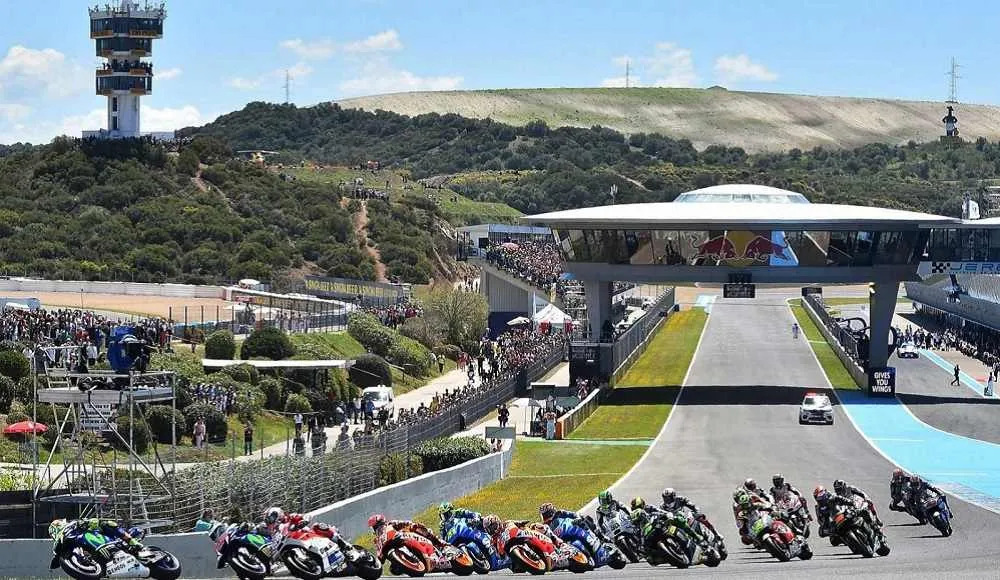 Close-up of a MotoGP bike hard on brakes entering a tight corner at Jerez with visible tire deformation