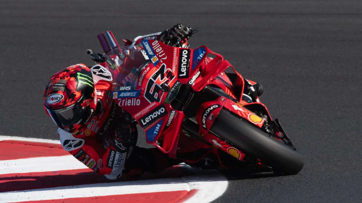 Pecco Bagnaia racing in his early MotoGP season, leaning into a corner with intense focus