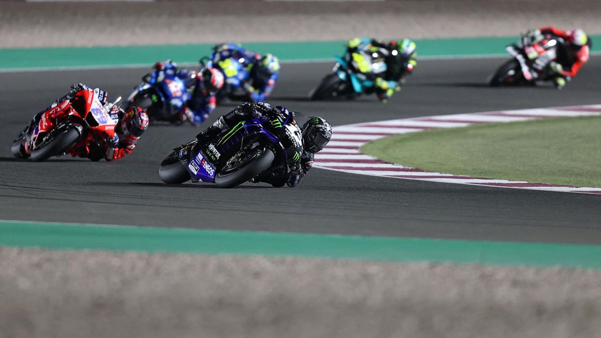 Race action from an early lightweight class at Losail with riders negotiating a sweeping corner