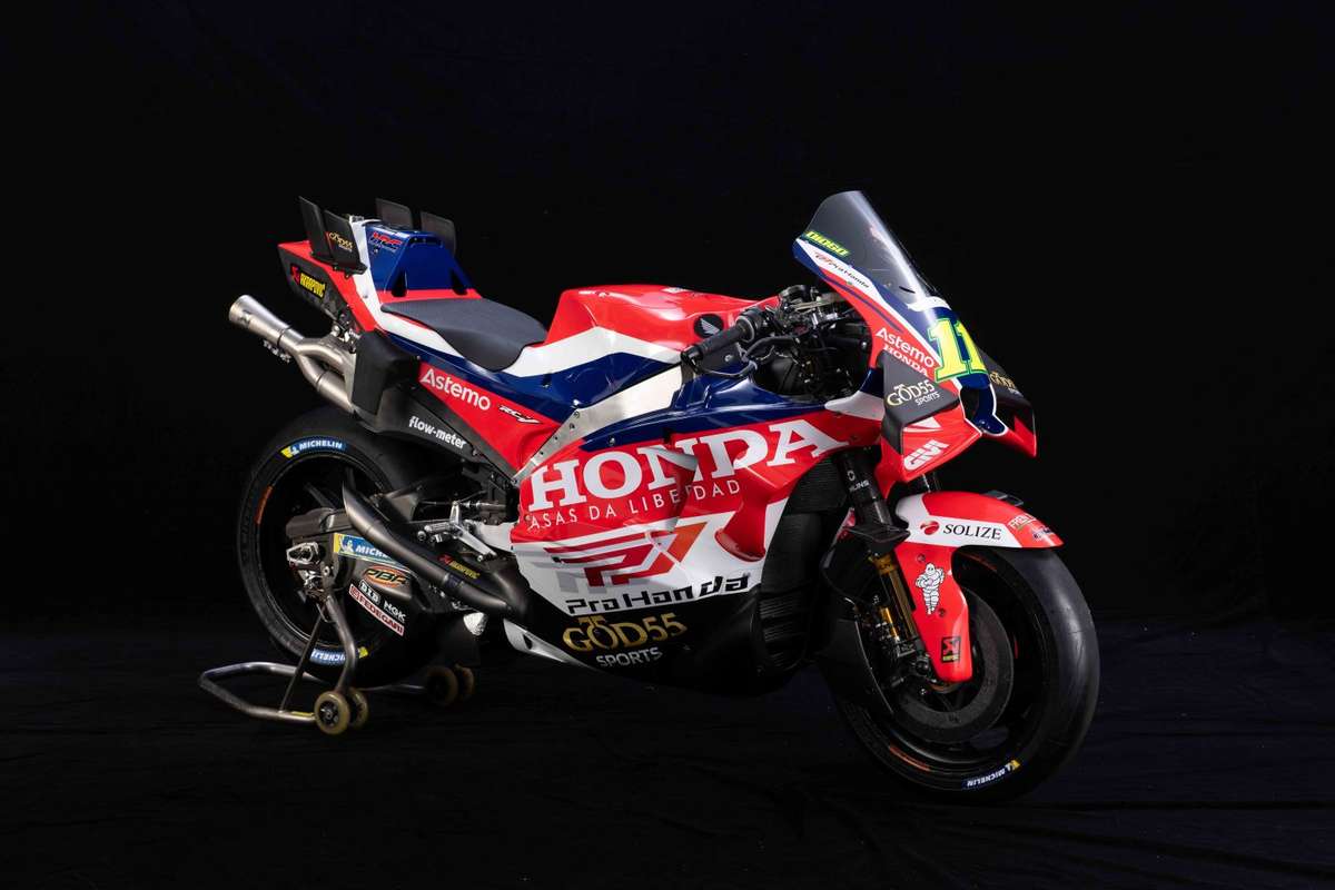 Honda RC213V leaned over at high speed on a race track with rider in full lean