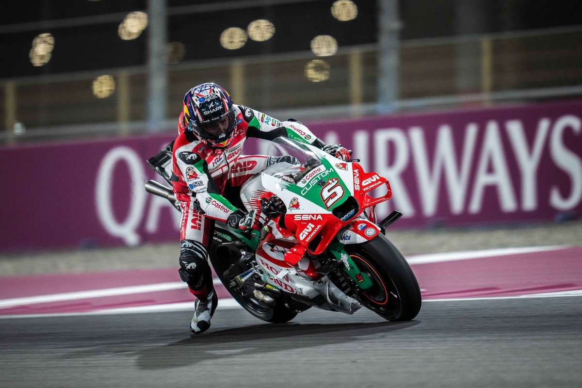 Zarco making subtle bodywork adjustments on the Honda between practice sessions, engineers observing